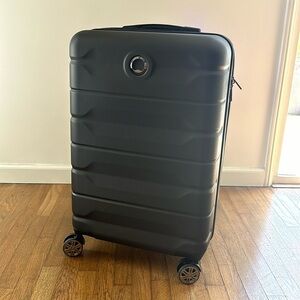 Brand new black Delsey 23 inch spinner luggage bag
